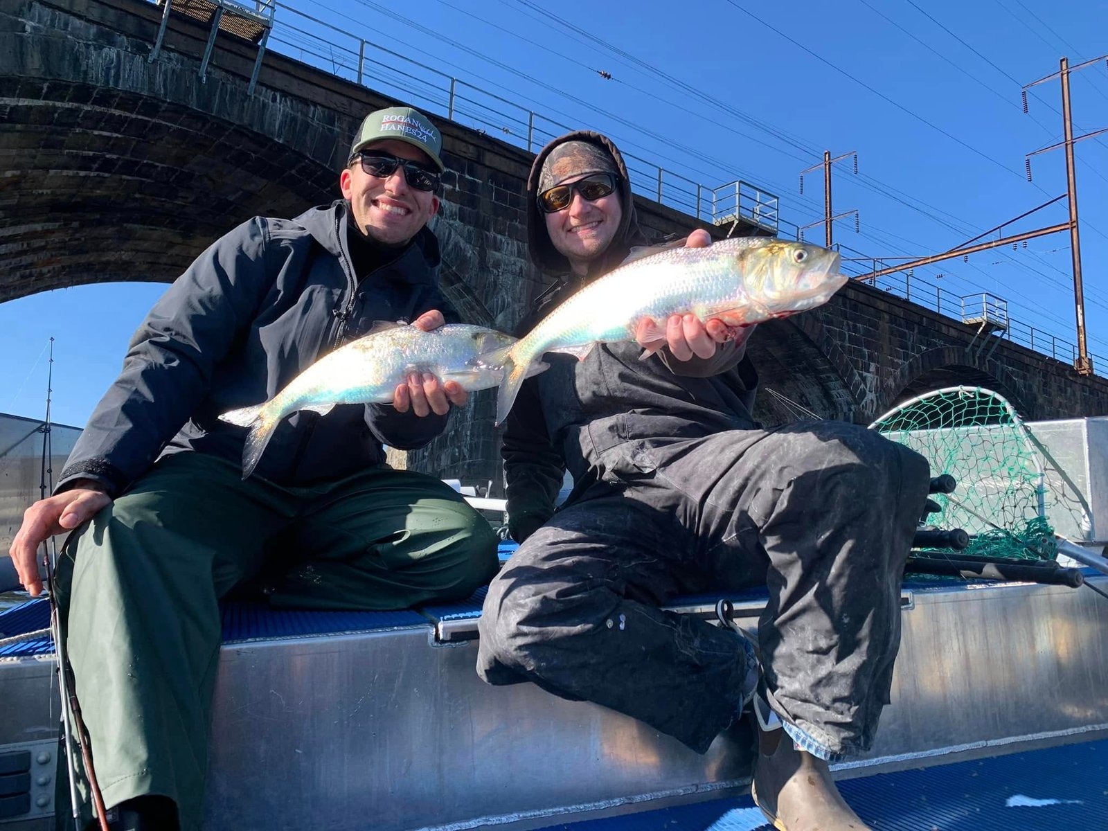 Two anglers holding American Shad caught on the Delaware River